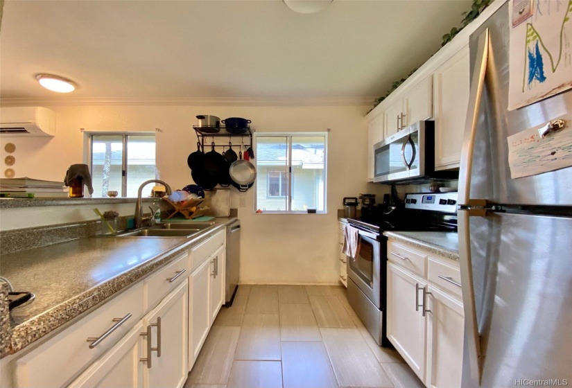 Galley style kitchen, open and bright w/stainless steel