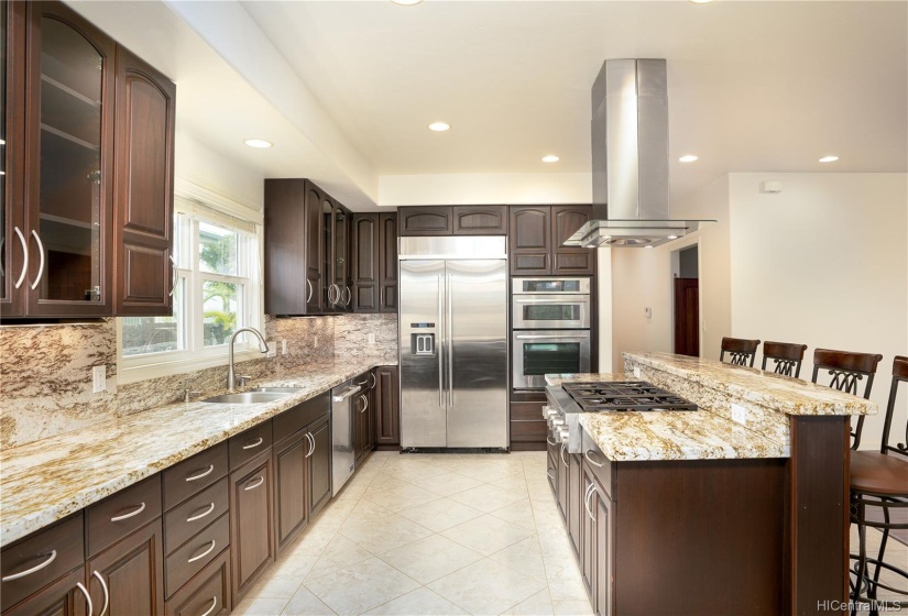 Spacious functional kitchen with stainless steel appliances.