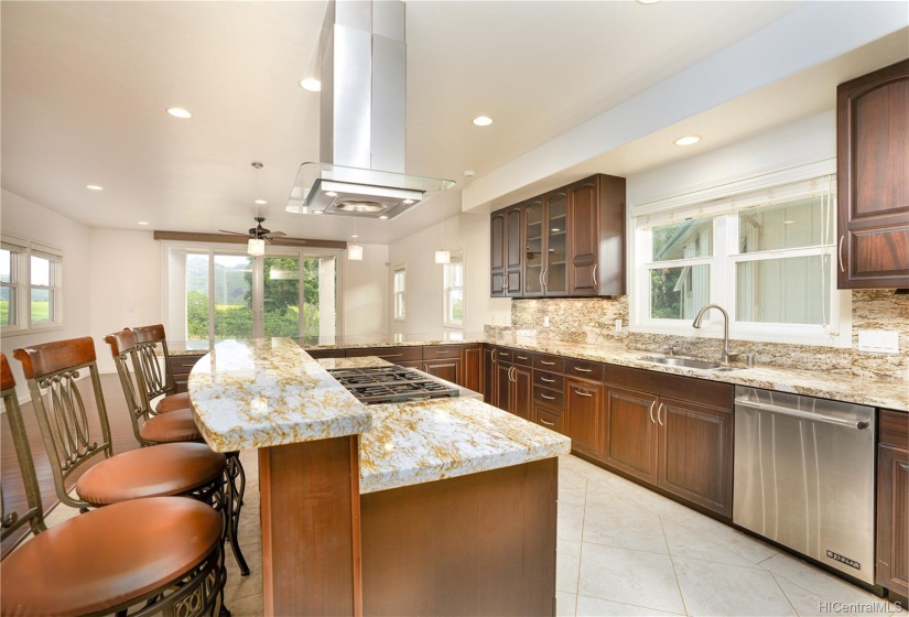 Kitchen equipped with a 6 burner gas stove and island counter.