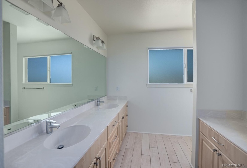 Owner's suite bathroom showcasing a double sink vanity and extra counter space to the right.