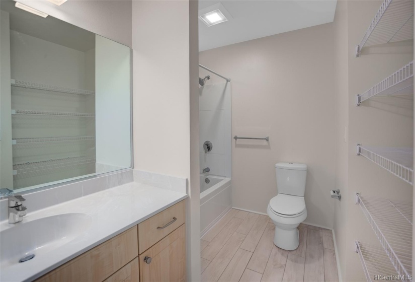 Full size bathroom upstairs with extra shelving to the right for linens.