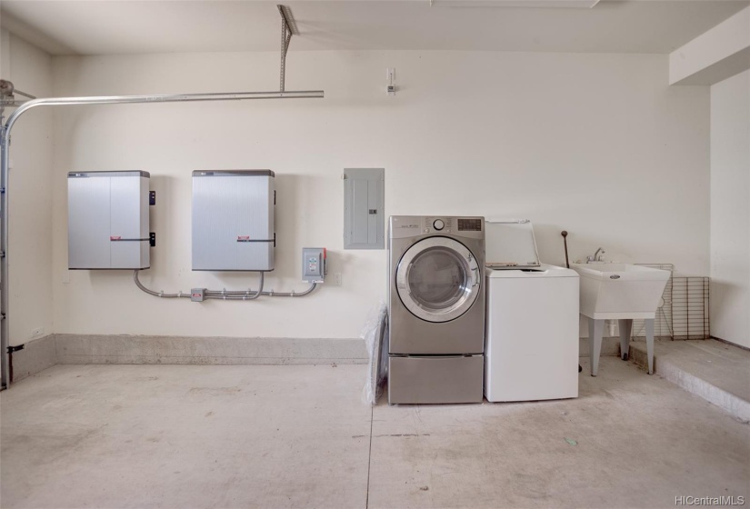 One car garage. Washer and dryer tucked away in the garage and PV panel system to the left.