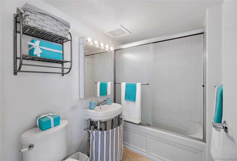 Shower sliding doors and tiled floor.