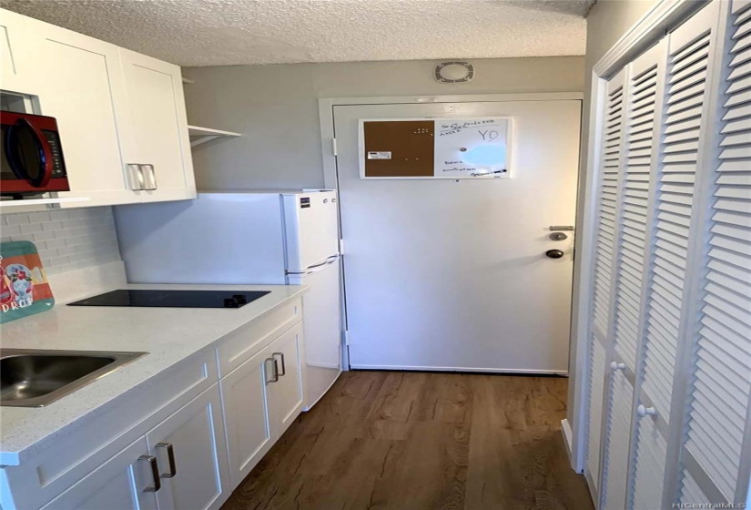 view from living area to kitchen and main door