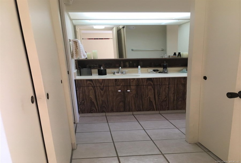 Hallway to bathroom with washer/dryer to the left, and closet to the right.