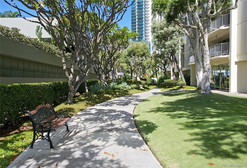 A walking path takes you through some treelined gardens