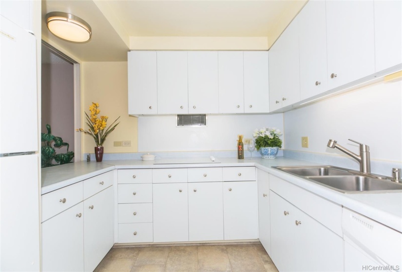 Kitchen is equipped with a large pantry, a new solid surface range top and oven, and lots of cabinets and drawer storage