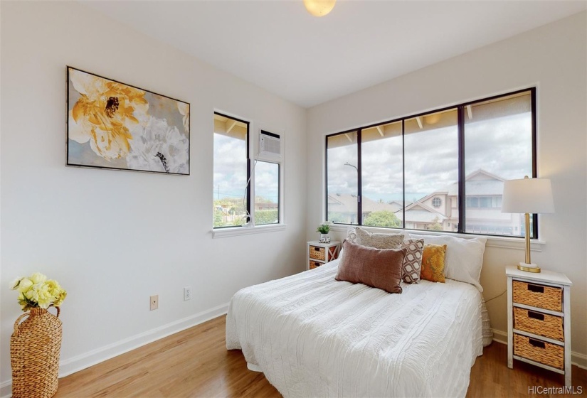 This upstairs bedroom features large windows to allow for ample natural light with window A/C to cool you down