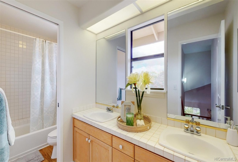 Enjoy the flexibility of the upstairs bathroom as the sliding privacy door separates the shower/toilet and sinks