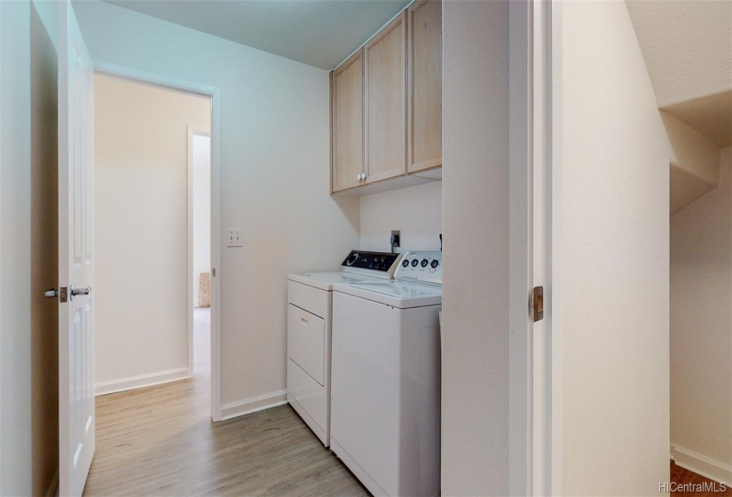 You'll appreciate this laundry area with tons of storage underneath the stairs