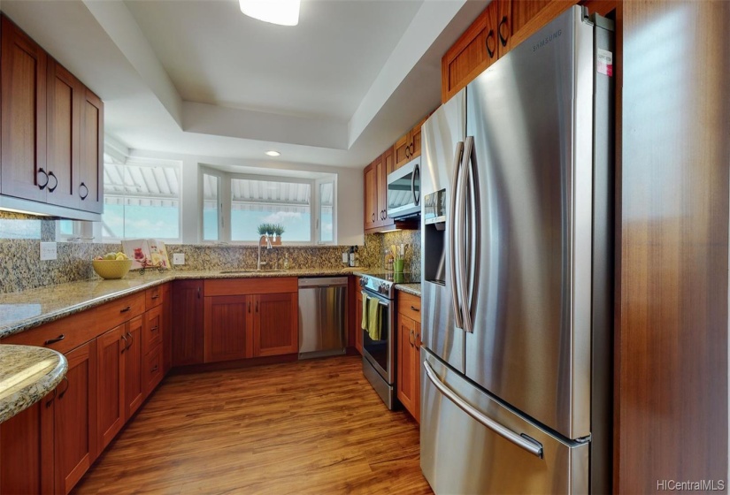 The beautifully renovated kitchen includes new Samsung stainless steel appliances, soft close drawers & cabinets, and granite countertops.