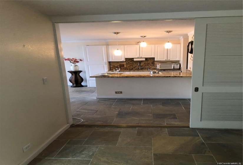 2nd bedroom with pocket sliding doors looking towards the kitchen.