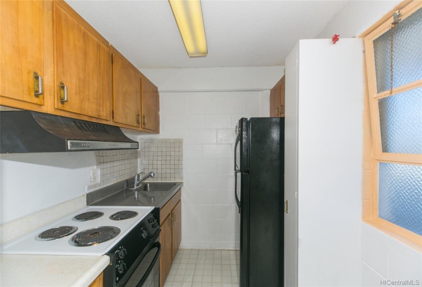 Kitchen area with fridge and stove