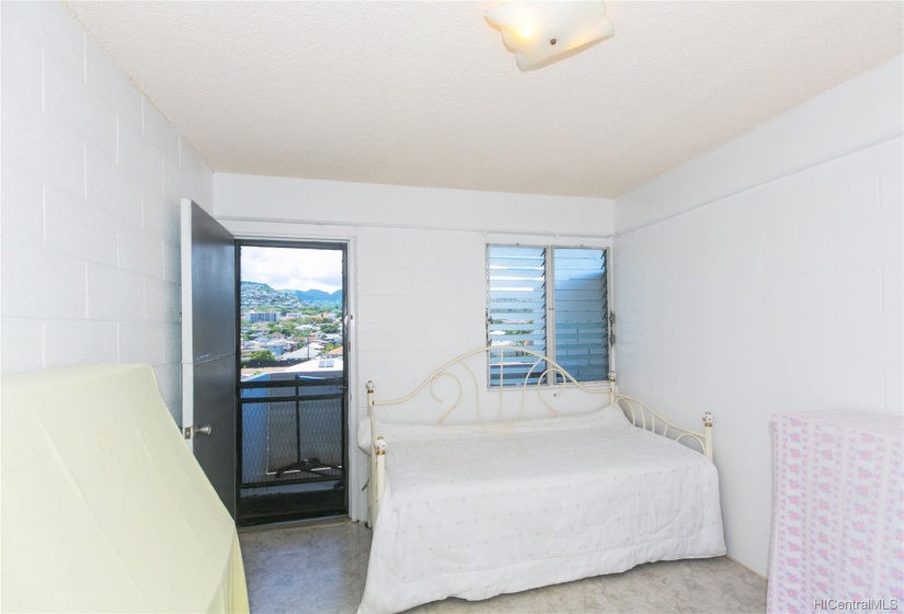 main bedroom with door to the balcony. Great breeze comes through here