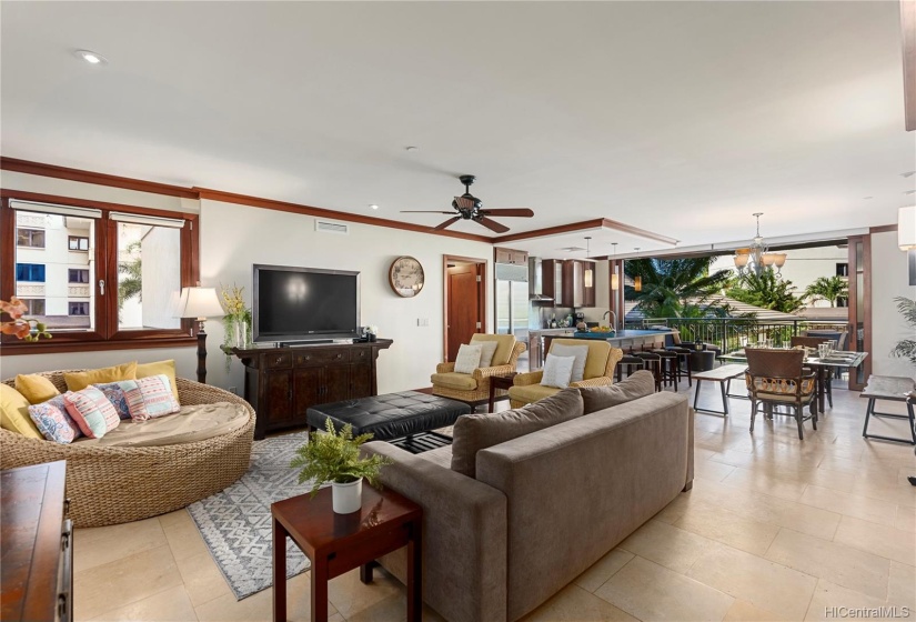 Large living area with comfortable seating, flat screen TV, central AC and ceiling fan