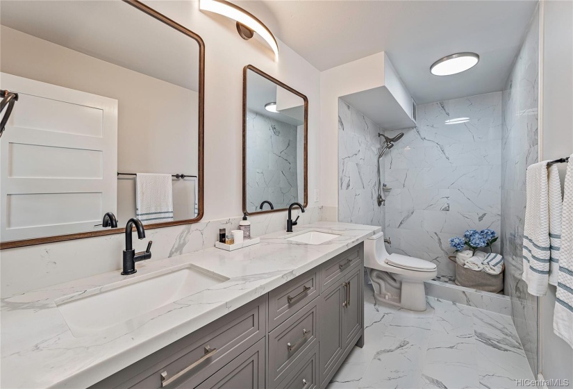 Spa-like retreat in this gorgeous bath. Double sinks with marble counters, floors and shower. Bright and spacious.