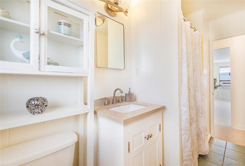 Clean and bright hallway bathroom with newer vanity