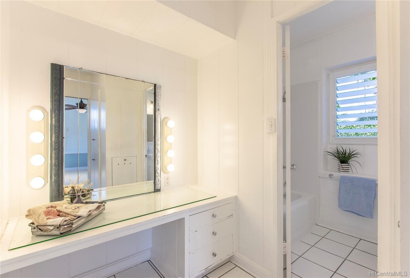 Main house primary bedroom, vanity into shower/bath