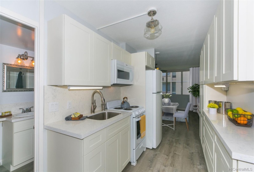 Full Bath on left, remodeled kitchen. Cabinets and surfaces all new give a wonderful clean look.