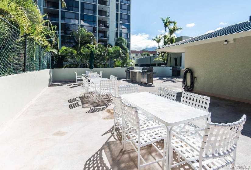 Pool deck including BBQ stations.