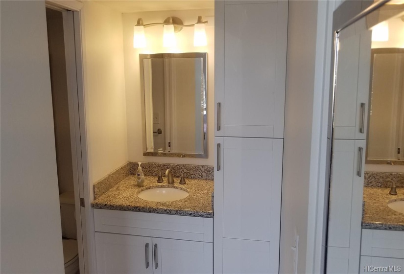 An ew bathroom vanity was installed with granite counter tops and new storage closet.