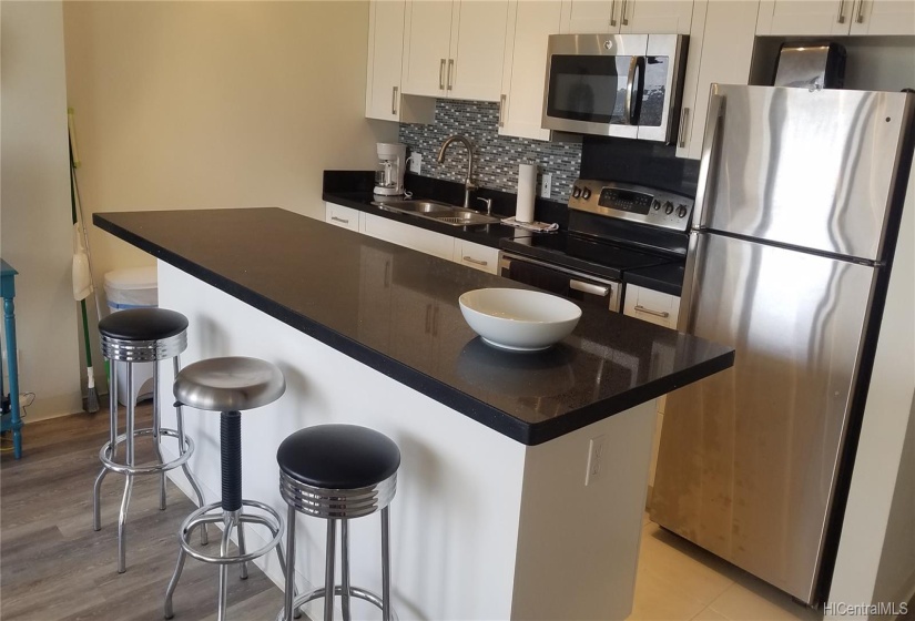 The kitchen remodel included tiled backsplash and stainless steel appliances.