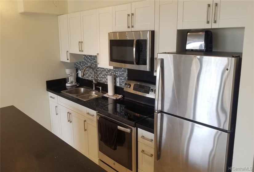 The kitchen island is wide enough to give a lot of prep area for cooking or eating.