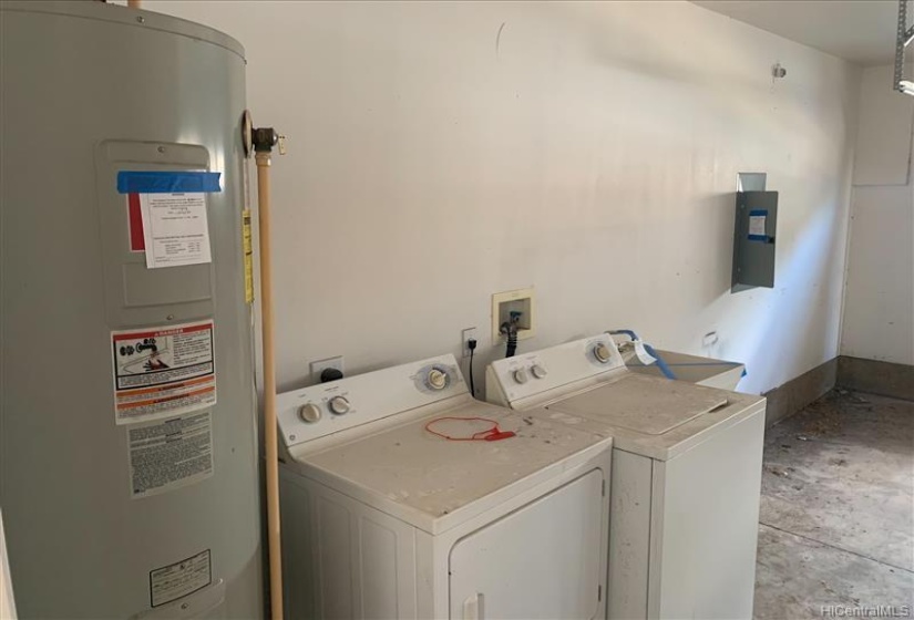 Washer/Dryer and water heater located in garage.