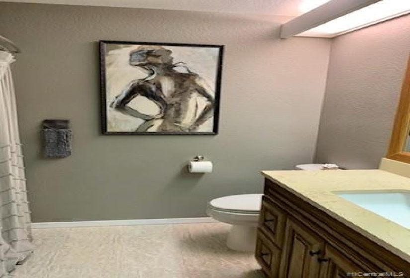 main bath with upgraded vanity and tile floors.