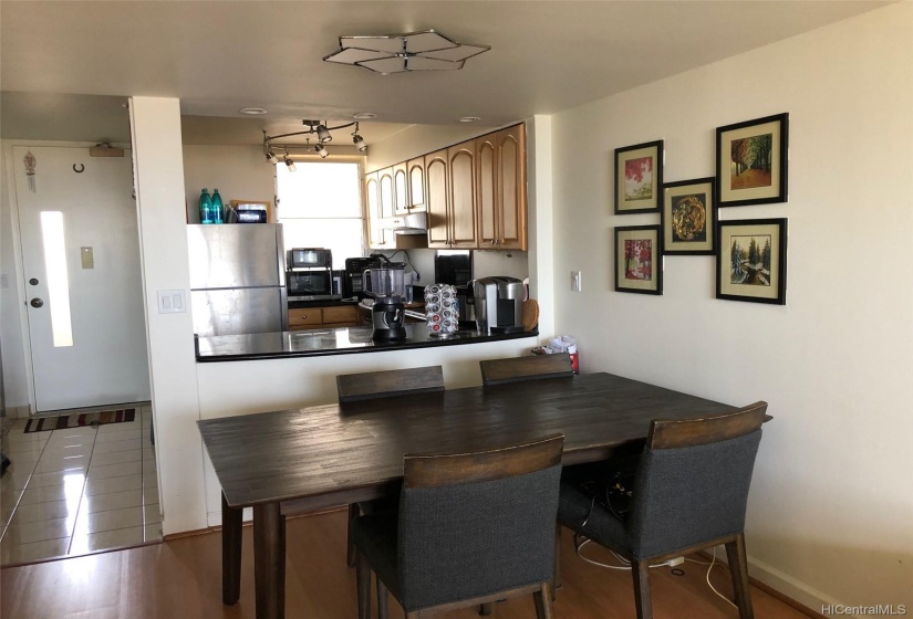 Entrance door to the unit with the kitchen counter and dining area