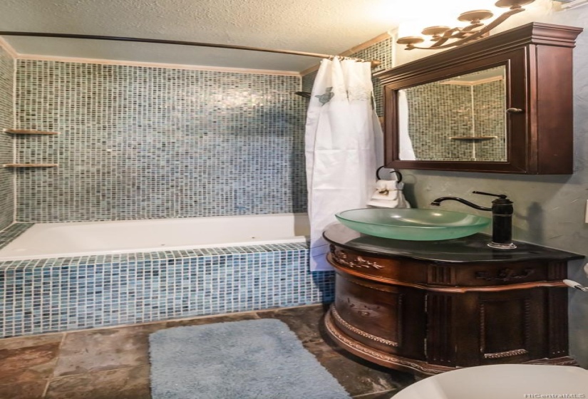 venetian glass tile surrounding the tub. venetian plaster on walls