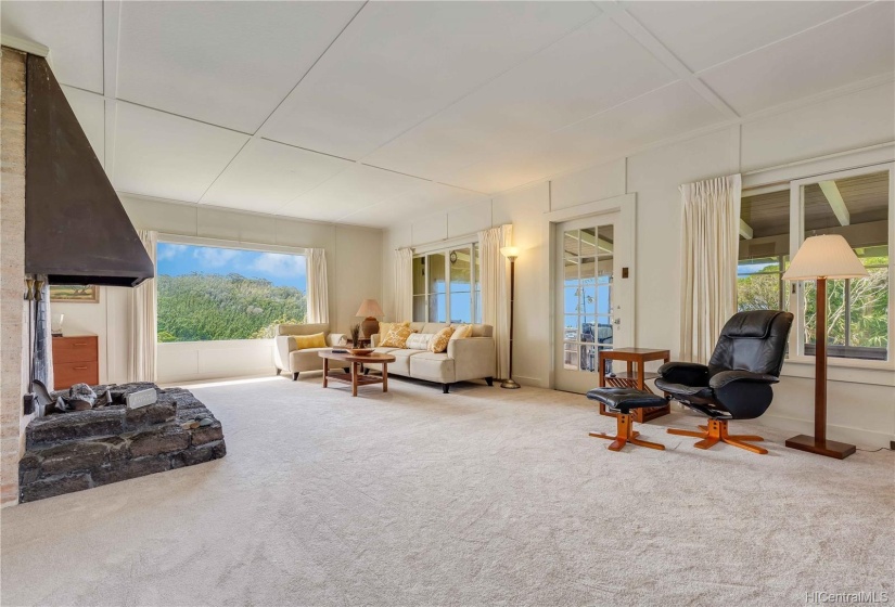 Enormous living room with 10 ft ceilings welcomes you home