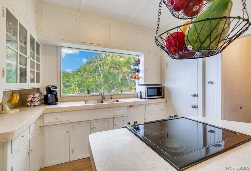 Charming kitchen with glass front cabinets and new counter tops