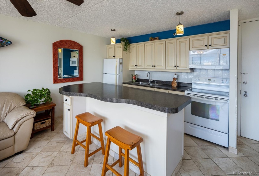 Kitchen island/bar serves as extra counter space and seating.