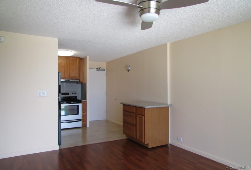 Mobile kitchen island with storage for convenient prep space. Laminate flooring in the living room and bedroom.  Ceramic tile kitchen flooring.