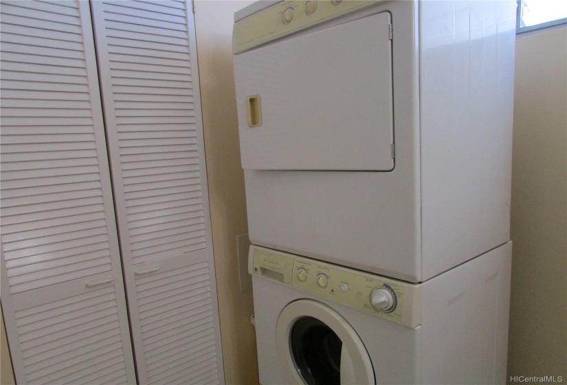 High efficiency front load washer and dryer conveniently located in your unit.  Added storage cabinets to the left.