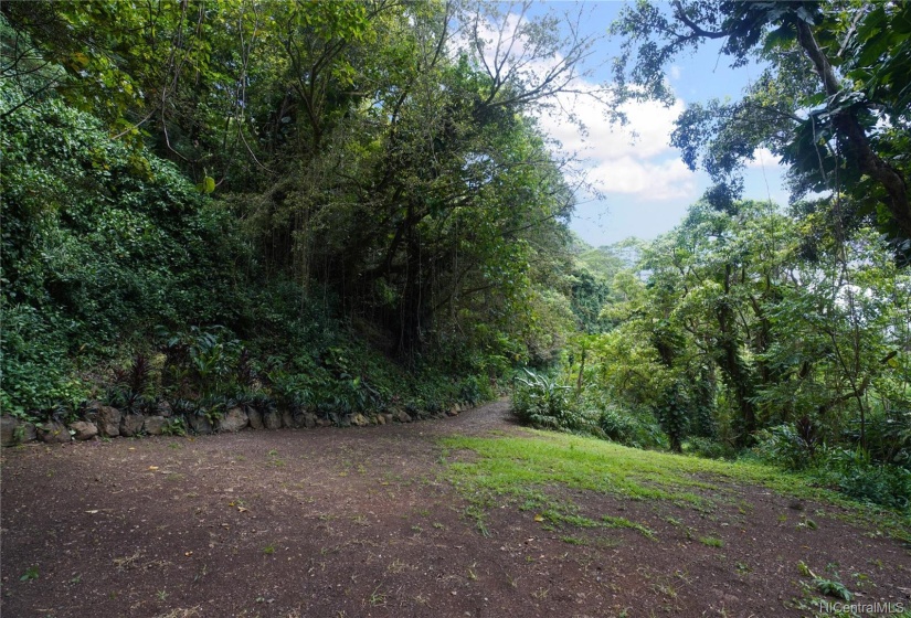 A building side and the connection to the foot path meandering through the property.