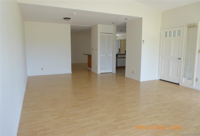 Living room looking to garage and half bath.