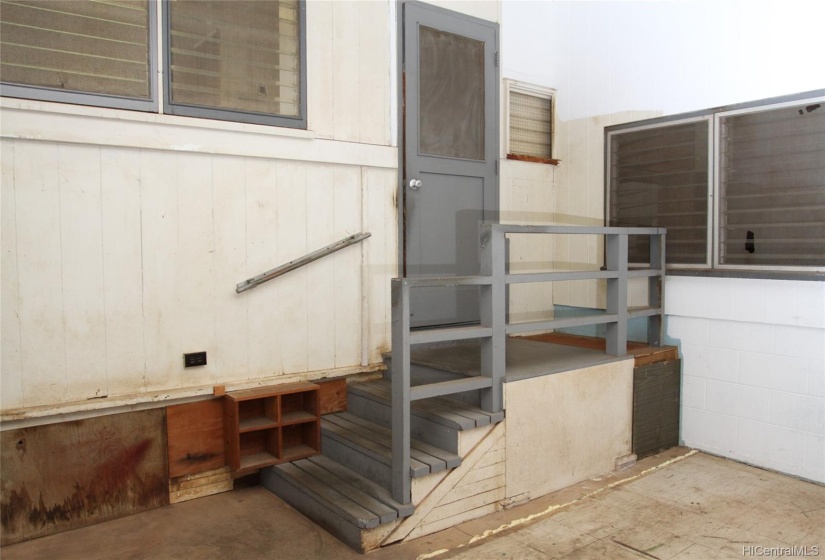 Kitchen door leads out to the enclosed patio and backroom.