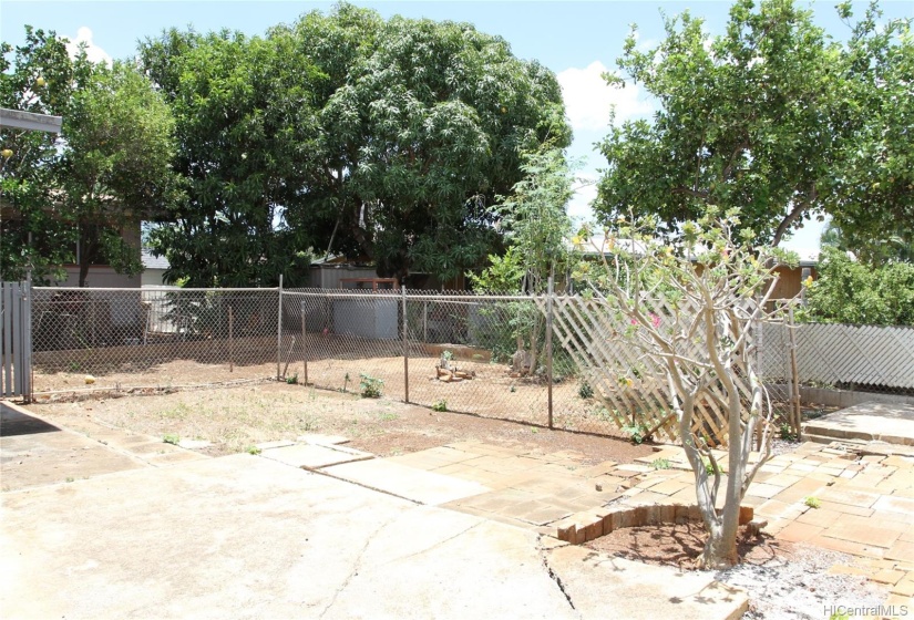 Level backyard with a portion partly fenced in.