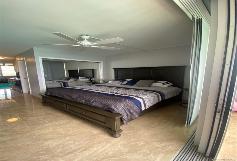 Bedroom with king bed with built in USB ports.  Ceiling light fan added.  Pocket sliding glass doors on lanai, sliding door screens and black out designer shades