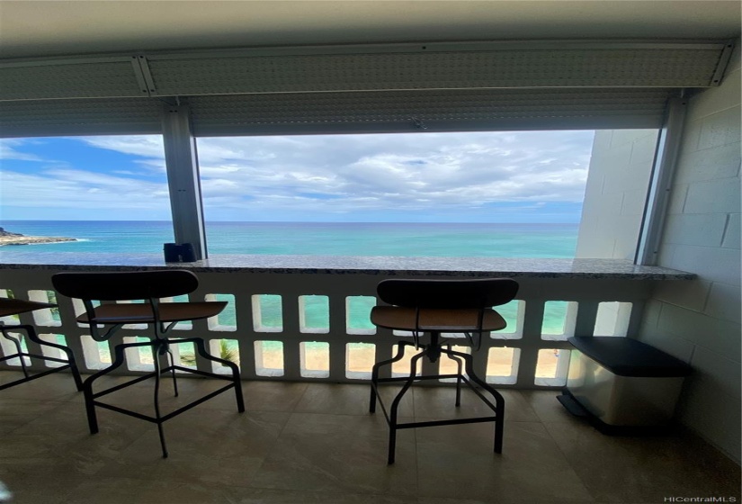 Lanai has ceramic tile flooring, granite top bar, bar stools and hurricane shutters.  Watch the turtles and whales from this vantage point