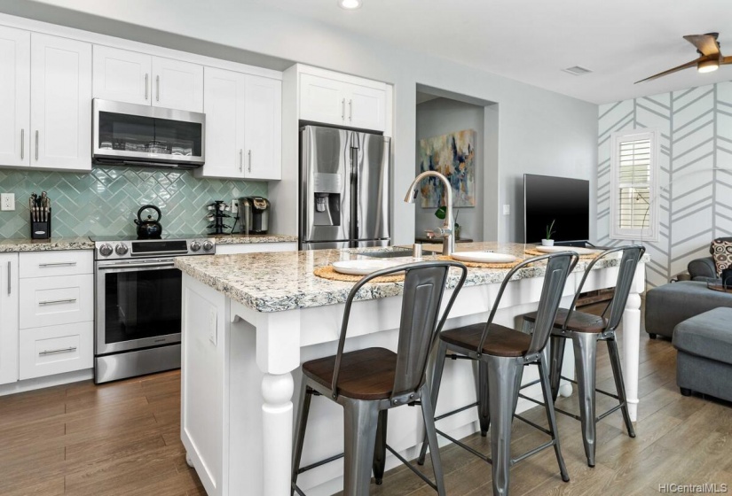 All granite countertops with glazed tile backsplash.