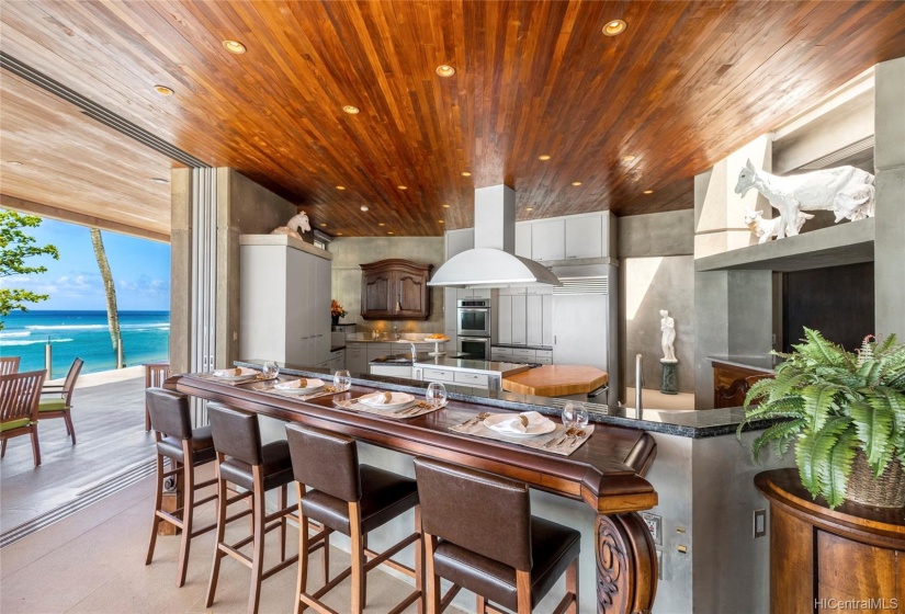 Custom antique pieces from European travels are placed throughout the home shown here with the breakfast bar and the far wall cabinetry.