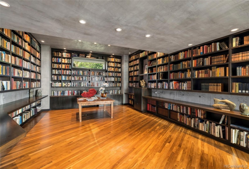 A stunning library that can house 6,000 of your best books. Reading chairs, not shown, are situated to bring in the views of the palm tree's and water.