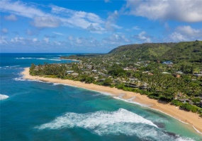 Sunset Beach, North Shore O'ahu. This stretch of sand is truly magical! Hale Paumalu- House of Sunset is seen here, in the middle of the beach.