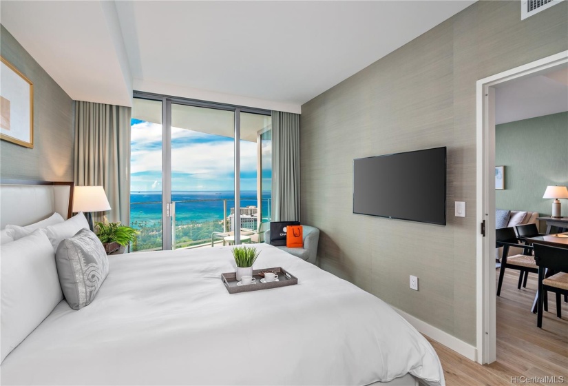 Guest bedroom off the living room features Gorgeous Ocean Views with access to Lanai, en-suite Bathroom!