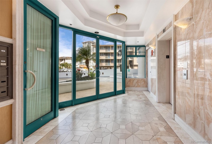 Ground floor of the lobby entrance. To the left is the Site Manager and to the right is the elevator.