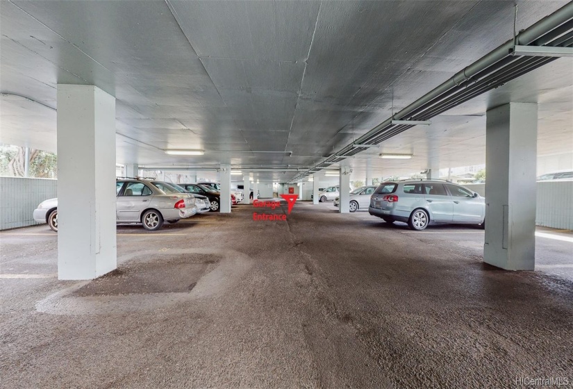 The lower level of the parking garage with wide driveway is well maintained.