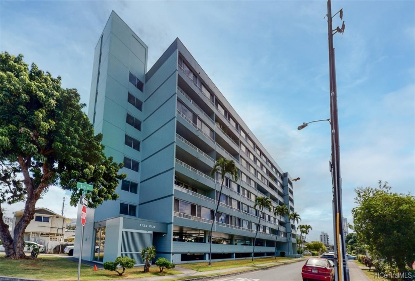 Front of the building from the corner of Piikoi and Elm, looking east.  The loading zone/temporary parking is near the tree in the left of the photo.